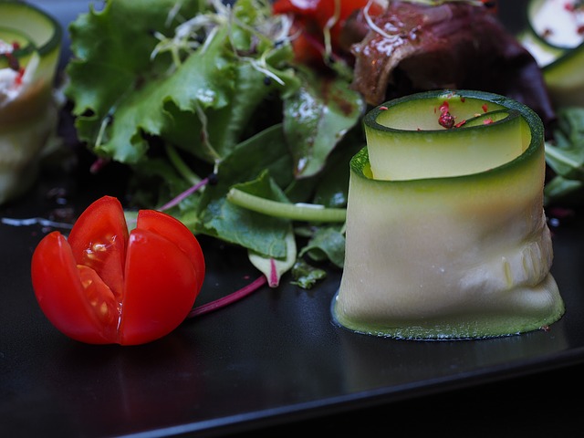 Baby tomato, with zucchini roll up makes a salad more fun and attractive.