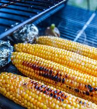 Roasting sweet corn on the grill with potatoes. Yum!