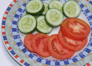 Sliced tomatoes and cucumbers ready for the table.